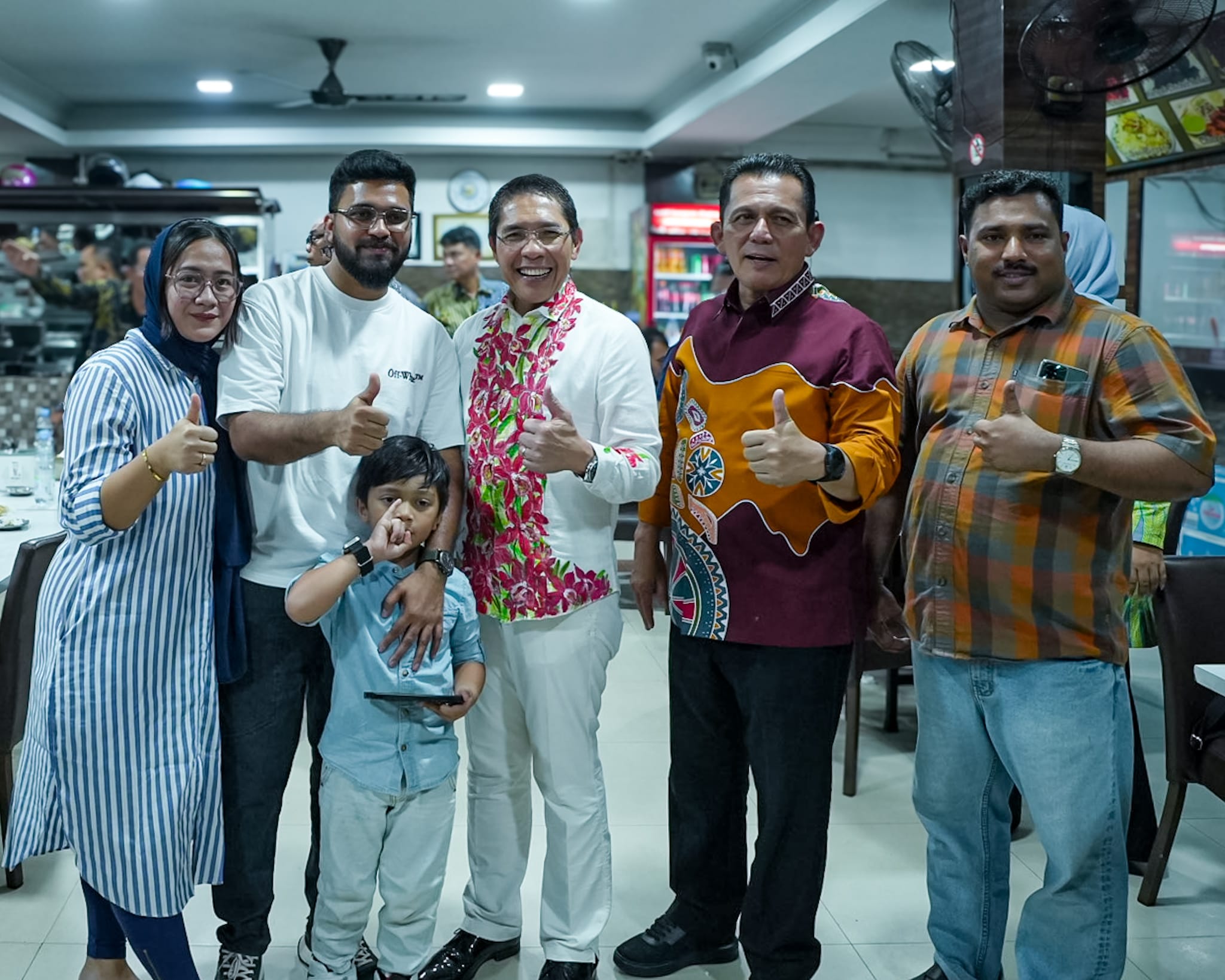 People at a meeting table with Singapore, Austria, and EU flags behind them.